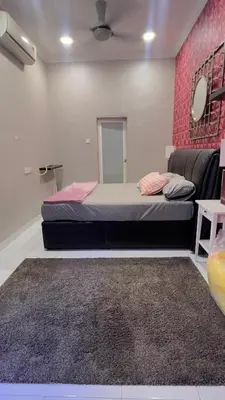 a bedroom with a bed and a pink wall at Md homestay in Kampong Kubang Menderong