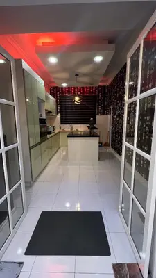 a large kitchen with a large white tile floor at Md homestay in Kampong Kubang Menderong