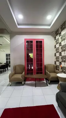 a lobby with two chairs and a table in a room at Md homestay in Kampong Kubang Menderong