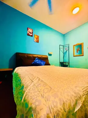 a bedroom with a bed with blue walls at charming 1br retreat in bayan lepas 1car park Malaysian guest only Netflix in Bayan Lepas