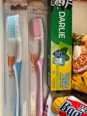 a refrigerator with two toothbrushes and a bag of food at 2br bayan lepas 1car park Malaysian guest only in Bayan Lepas