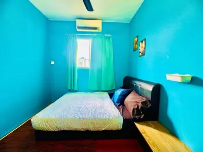 a blue room with a bed and a window at 2br bayan lepas 1car park Malaysian guest only in Bayan Lepas