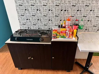 a counter with a stove and some food on it at 2br bayan lepas 1car park Malaysian guest only in Bayan Lepas