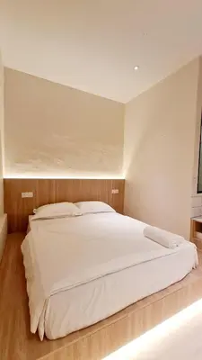 a bedroom with a large white bed in it at Kazuki Boutique Accommodation in George Town