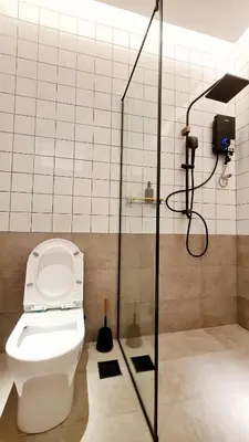 a bathroom with a toilet and a shower at Kazuki Boutique Accommodation in George Town