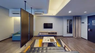 a lobby with a couch and a table and a tv at Tropics Eight Suites in George Town