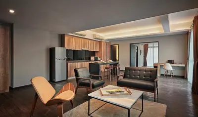 a living room with a couch and a table in a room at Tropics Eight Suites in George Town
