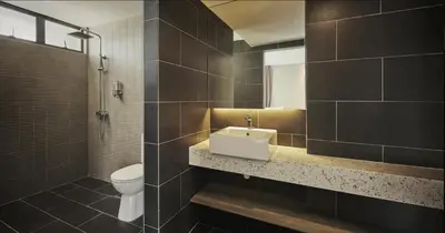 a bathroom with a sink and a toilet at Tropics Eight Suites in George Town