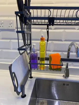 a dish rack next to a sink with bottles in it at Cozy 2BR Sky Pool & Panoramic Views 1-6 Guests in Bayan Lepas