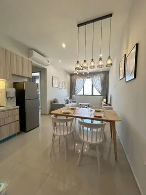 a kitchen and dining room with a table and chairs at Cozy 2BR Sky Pool & Panoramic Views 1-6 Guests in Bayan Lepas
