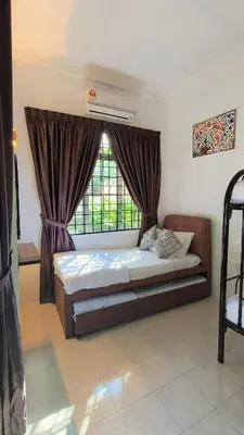 a bedroom with a bed and a window at Frangipine Villa in Tapah