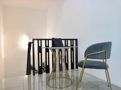 a chair and a table with a laptop on it at Do not book in Ipoh