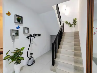 a scooter is parked next to a staircase in a house at Do not book in Ipoh