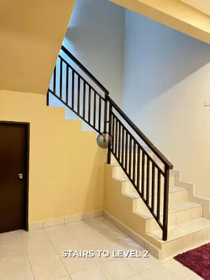 a staircase in a house with a black door at Senja Stay Homestay Kulim in Kulim