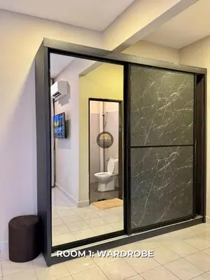 a bathroom with a toilet and a glass door at Senja Stay Homestay Kulim in Kulim