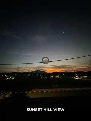 a view of the sunset from a window at Senja Stay Homestay Kulim in Kulim