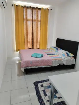 a small bed in a room with a window at Al Qarni Homestay 1 in Ipoh
