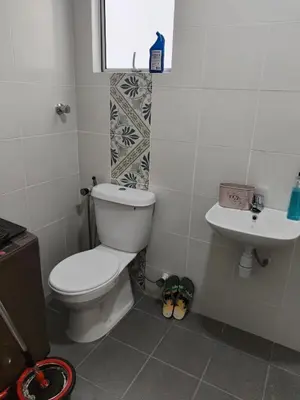 a bathroom with a toilet and a sink at Al Qarni Homestay 1 in Ipoh