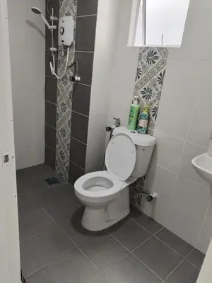 a bathroom with a toilet and a sink at Al Qarni Homestay 1 in Ipoh