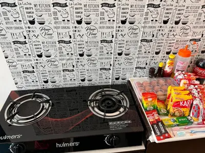 a kitchen with a stove top with a bunch of food at 1br 2pax 1car only Malaysian guest only in Bayan Lepas