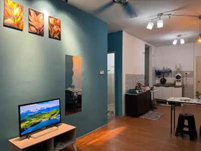 a living room with a computer on a desk at 1br 2pax 1car only Malaysian guest only in Bayan Lepas