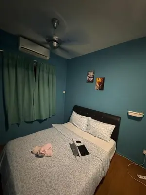a person laying on a bed with a laptop on it at 2pax 1car only Malaysian guest only bayan lepas in Bayan Lepas