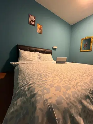a bedroom with a bed with a laptop on it at 2pax 1car only Malaysian guest only bayan lepas in Bayan Lepas