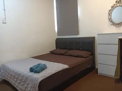 a bedroom with a bed with a blue object on it at ManMai Homestay Mesra Solat Double Storey in Nibung Tebal