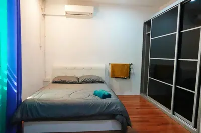 a small bedroom with a bed in a room at ManMai Homestay Mesra Solat Double Storey in Nibung Tebal
