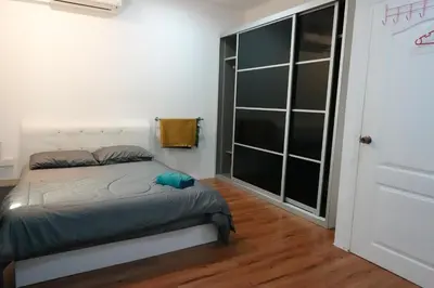a bedroom with a bed and a large window at ManMai Homestay Mesra Solat Double Storey in Nibung Tebal