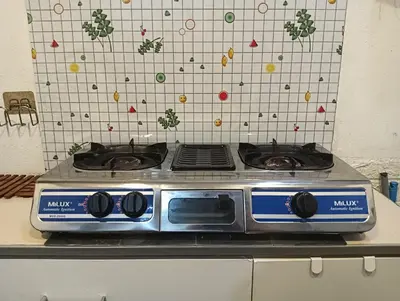 a stove top oven sitting on top of a counter at ManMai Homestay Mesra Solat Double Storey in Nibung Tebal