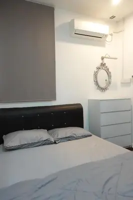 a bedroom with a bed and a mirror on the wall at ManMai Homestay Mesra Solat Double Storey in Nibung Tebal