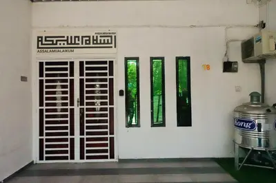 a white door with windows on a white wall at ManMai Homestay Mesra Solat Double Storey in Nibung Tebal