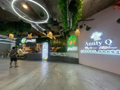 a man standing in front of an empty restaurant at Comfort 1BR studio One One Eight Island Plaza in Tanjong Tokong