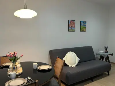 a living room with a couch and a table at Comfort 1BR studio One One Eight Island Plaza in Tanjong Tokong