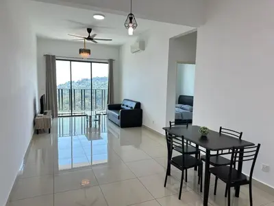 a living room with a dining room table and a couch at HappySty in Bayan Lepas
