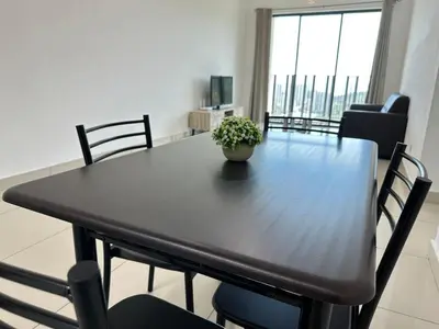 a dining room table with a potted plant on it at HappySty in Bayan Lepas