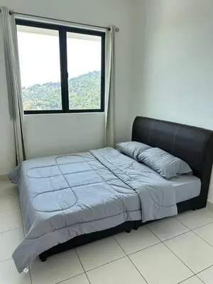 a bed in a room with a large window at HappySty in Bayan Lepas