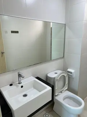 a bathroom with a sink and a toilet and a mirror at HappySty in Bayan Lepas