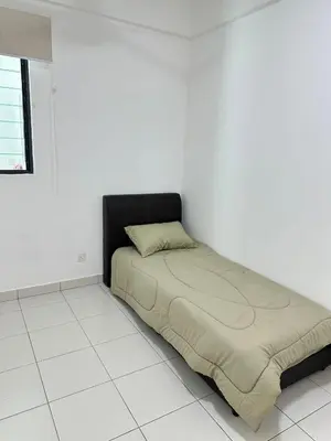 a bed in the corner of a room at HappySty in Bayan Lepas