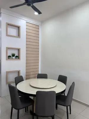 a dining room with a circular table and chairs at Naura Homes Penang in Kampong Batu Maung