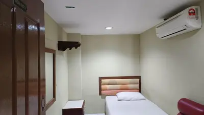 a small room with two beds and a heater at HOTEL MEDAN KiDD in Ipoh