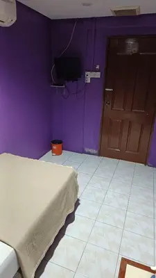 a purple room with a bed and a door at HOTEL MEDAN KiDD in Ipoh