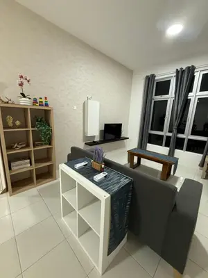 a living room with a couch and a table at Kyra's Downtown Delight in Ipoh