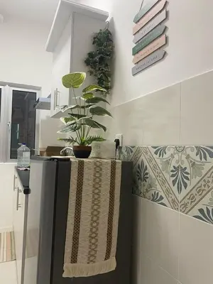 a bathroom with a towel and books on the wall at Kyra's Downtown Delight in Ipoh