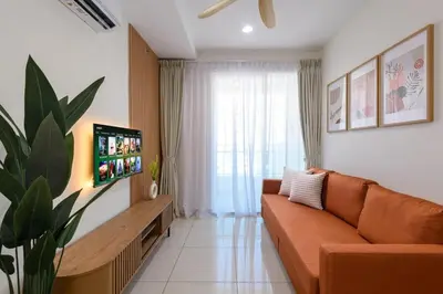 a living room with a couch and a flat screen tv at 2R2B Lovely Home 1-8pax Gurney Mansion One in George Town
