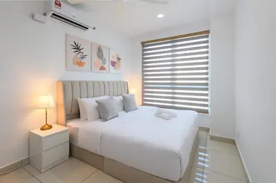 a white bedroom with a white bed and a window at 2R2B Lovely Home 1-8pax Gurney Mansion One in George Town