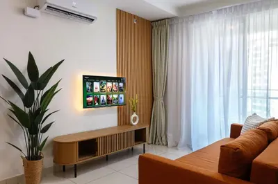 a living room with a couch and a tv on a wall at 2R2B Lovely Home 1-8pax Gurney Mansion One in George Town
