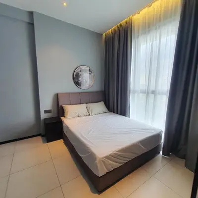 a bedroom with a bed and a large window at Urban Suites - Family Suite in Jelutong