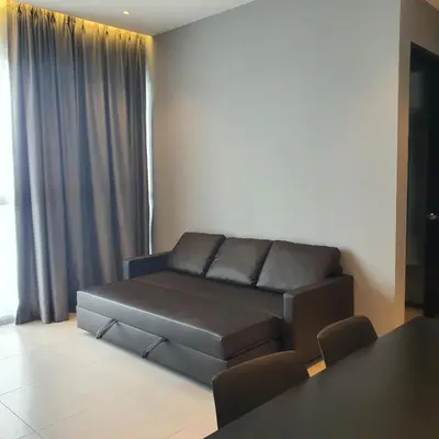 a living room with a couch and a table at Urban Suites - Family Suite in Jelutong